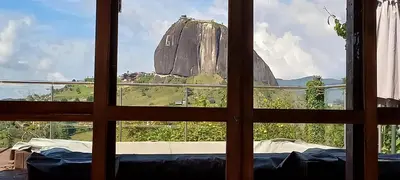 a view of a mountain from a window at Casa de Campo Bheta in Guatapé