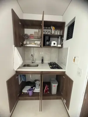 a small kitchen with a sink and a stove at Faro 201, 202, 203 Lujo en Laureles Ubicación Premium in Medellín