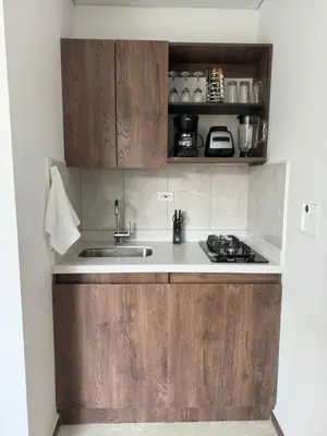 a kitchen with wooden cabinets and a sink at 22 Comfort and style in Medellín Laureles in Medellín