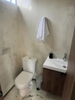 a bathroom with a white toilet and a sink at 22 Comfort and style in Medellín Laureles in Medellín