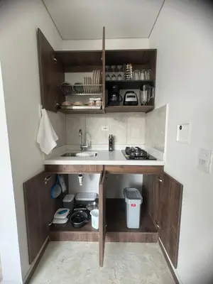a kitchen with a sink and wooden cabinets at 22 Comfort and style in Medellín Laureles in Medellín