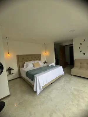 a bedroom with a large bed and a couch at 22 Comfort and style in Medellín Laureles in Medellín