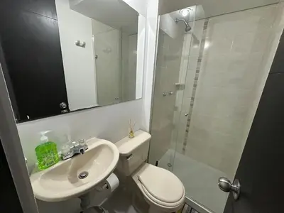 a bathroom with a toilet and a sink and a shower at Hermoso apartamento amoblado Sabaneta1309 in Sabaneta