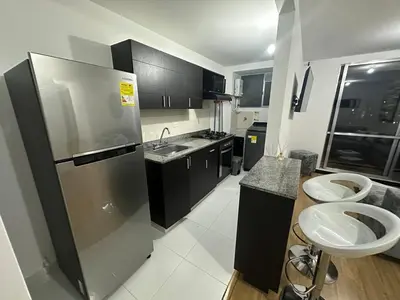 a kitchen with two sinks and a stainless steel refrigerator at Hermoso apartamento amoblado Sabaneta1309 in Sabaneta