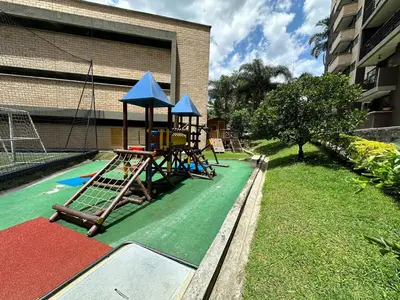 a playground with a slide and a swing set at Hermoso apartamento amoblado Sabaneta1309 in Sabaneta