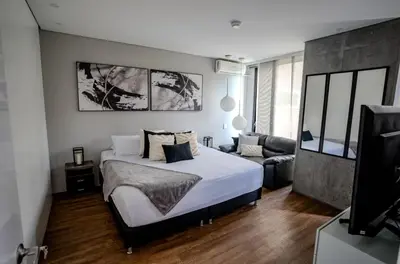 a bedroom with a bed and a living room at Energy Living - Luxury Apartment with Jacuzzi and Private Terrace in Medellín