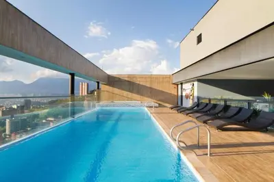 a swimming pool on the roof of a building at Energy Living - Luxury Apartment with Jacuzzi and Private Terrace in Medellín