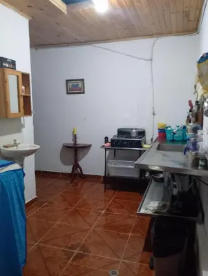 a kitchen with a counter and a sink in a room at Brisas del Río in Honda