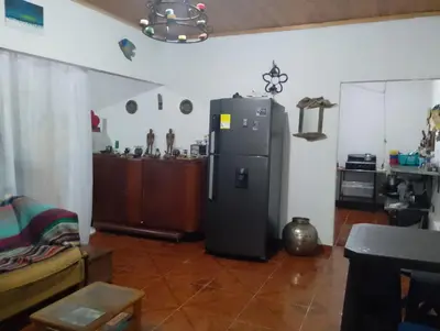 a kitchen with a refrigerator in a room at Brisas del Río in Honda