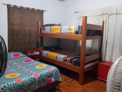 a bedroom with two bunk beds and a bed at Brisas del Río in Honda