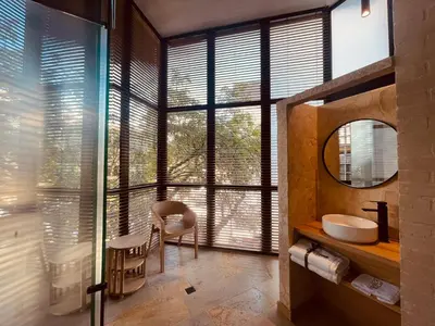 a bathroom with a sink and a large window at Hotel Boutique Obelisco in Medellín