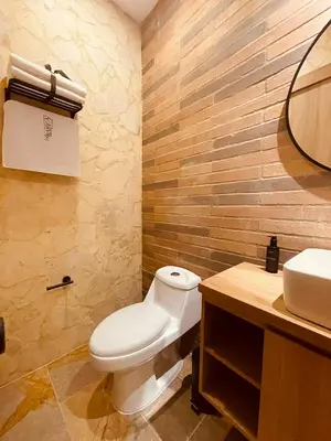 a bathroom with a white toilet and a sink at Hotel Boutique Obelisco in Medellín