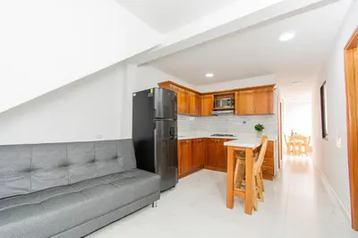 a kitchen with a couch and a table in a room at Aptos Familiares en Envigado con Aire Acondicionado in Envigado