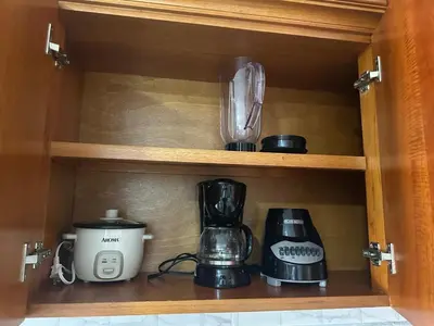 a cupboard with various appliances sitting on a shelf at Aptos Familiares en Envigado con Aire Acondicionado in Envigado