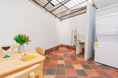 a kitchen with a counter and a table with a plate of food at Aptos Familiares en Envigado con Aire Acondicionado in Envigado