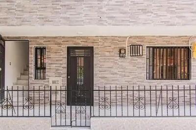 a house with a black fence in front of it at Aptos Familiares en Envigado con Aire Acondicionado in Envigado