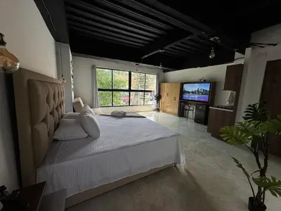 a large bedroom with a large bed and a television at 24 Laureles Prime Elegancia y Comodidad Medellín in Medellín
