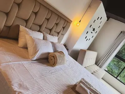 a bedroom with a large bed with a large headboard at 24 Laureles Prime Elegancia y Comodidad Medellín in Medellín