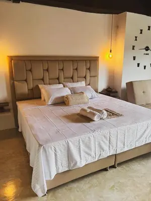 a bedroom with a large bed with two towels on it at 24 Laureles Prime Elegancia y Comodidad Medellín in Medellín