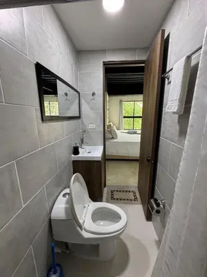 a bathroom with a toilet and a sink at 24 Laureles Prime Elegancia y Comodidad Medellín in Medellín