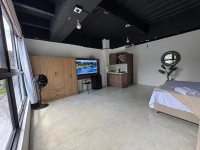 a bedroom with a bed and a flat screen tv at 24 Laureles Prime Elegancia y Comodidad Medellín in Medellín