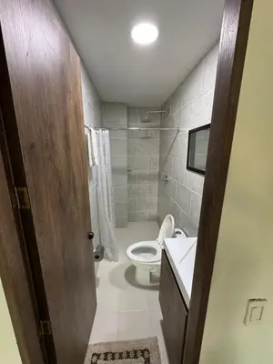 a bathroom with a toilet and a sink at 24 Laureles Prime Elegancia y Comodidad Medellín in Medellín