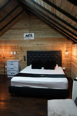 a bedroom with a large bed in a wooden wall at San Sebastián barbosa in Barbosa