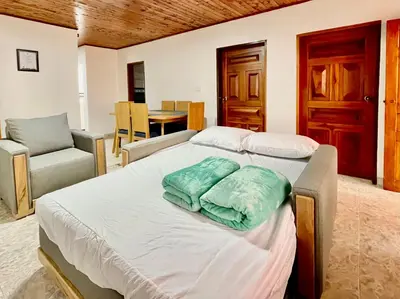 a bedroom with a bed with two pillows on it at Amplio apto 2 hab para familias y grupos Sabaneta in Sabaneta