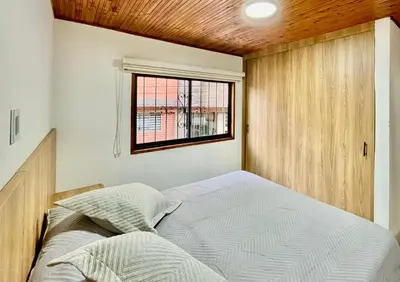 a bedroom with a bed and a window at Amplio apto 2 hab para familias y grupos Sabaneta in Sabaneta
