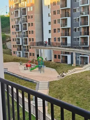 a playground in an apartment complex with buildings at Confortable Apartamento cerca Aeropuerto JMC unidad Cerrada in Rionegro