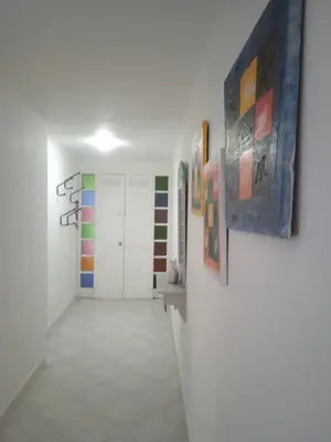 a hallway with colorful art on the walls at Apartamento vista lago 202 in Guatapé