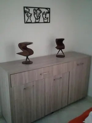 two chairs sitting on top of a wooden cabinet at Apartamento vista lago 202 in Guatapé
