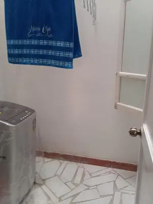 a bathroom with a washing machine and a blue towel at Apartamento vista lago 202 in Guatapé