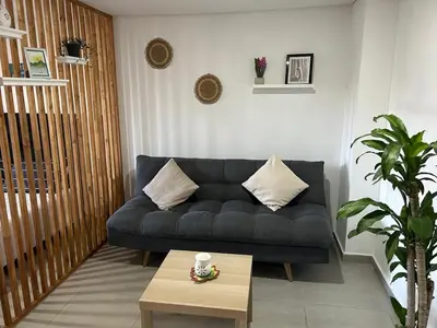 a living room with a blue couch and a coffee table at Apartamento Living La Ceja in La Ceja