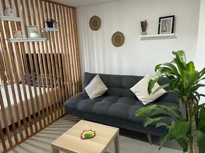 a living room with a blue couch and a table at Apartamento Living La Ceja in La Ceja