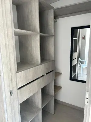 a built in book shelf in a room with a mirror at Apartamento Living La Ceja in La Ceja