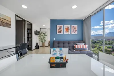 a living room with a white table and a couch at Vegas PH Suites in Medellín