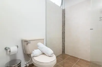 a bathroom with a toilet and a shower at Vegas PH Suites in Medellín