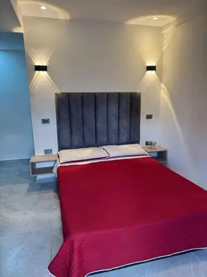 a large red bed in a room with lights at Villa Loreto Aparta estudio 301 in Medellín