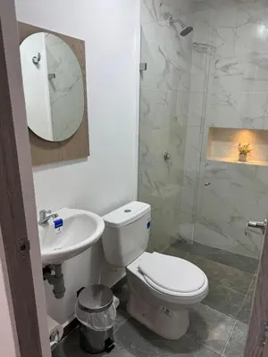 a bathroom with a toilet and a sink and a shower at Villa Loreto Aparta estudio 301 in Medellín