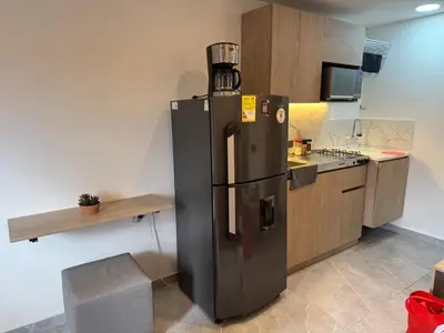 a large black refrigerator in a kitchen at Villa Loreto Aparta estudio 301 in Medellín