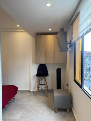 a living room with a chair and a window at Villa Loreto Aparta estudio 301 in Medellín