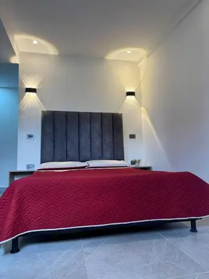 a bedroom with a large bed with a red bedspread at Villa Loreto Aparta estudio 301 in Medellín