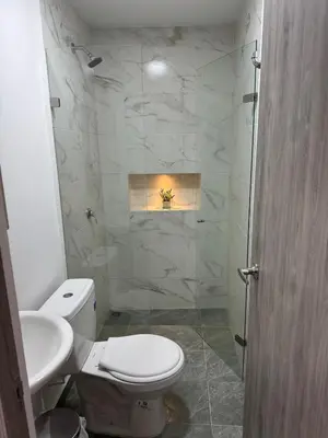 a bathroom with a toilet and a sink and a shower at Villa Loreto Aparta estudio 301 in Medellín