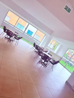 a group of tables and chairs in a room with windows at Apartamento moderno con balcón y vista a la ciudad cerca al mall plaza in Manizales