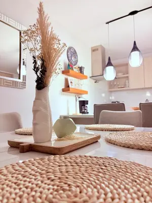 a dining room table with a vase on it at Apartamento moderno con balcón y vista a la ciudad cerca al mall plaza in Manizales