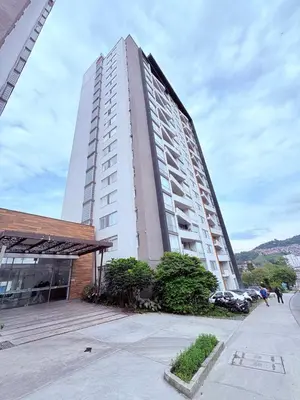 a tall building with people walking in front of it at Apartamento moderno con balcón y vista a la ciudad cerca al mall plaza in Manizales