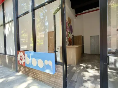 a store front with a sign on the side of a building at Bloom by Simple Stay in Medellín