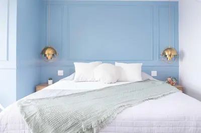 a bedroom with a white bed with blue walls at Exclusive Luxury Apartment - Poblado Medellín in Medellín