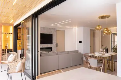 a dining room and living room with a table and chairs at Exclusive Luxury Apartment - Poblado Medellín in Medellín